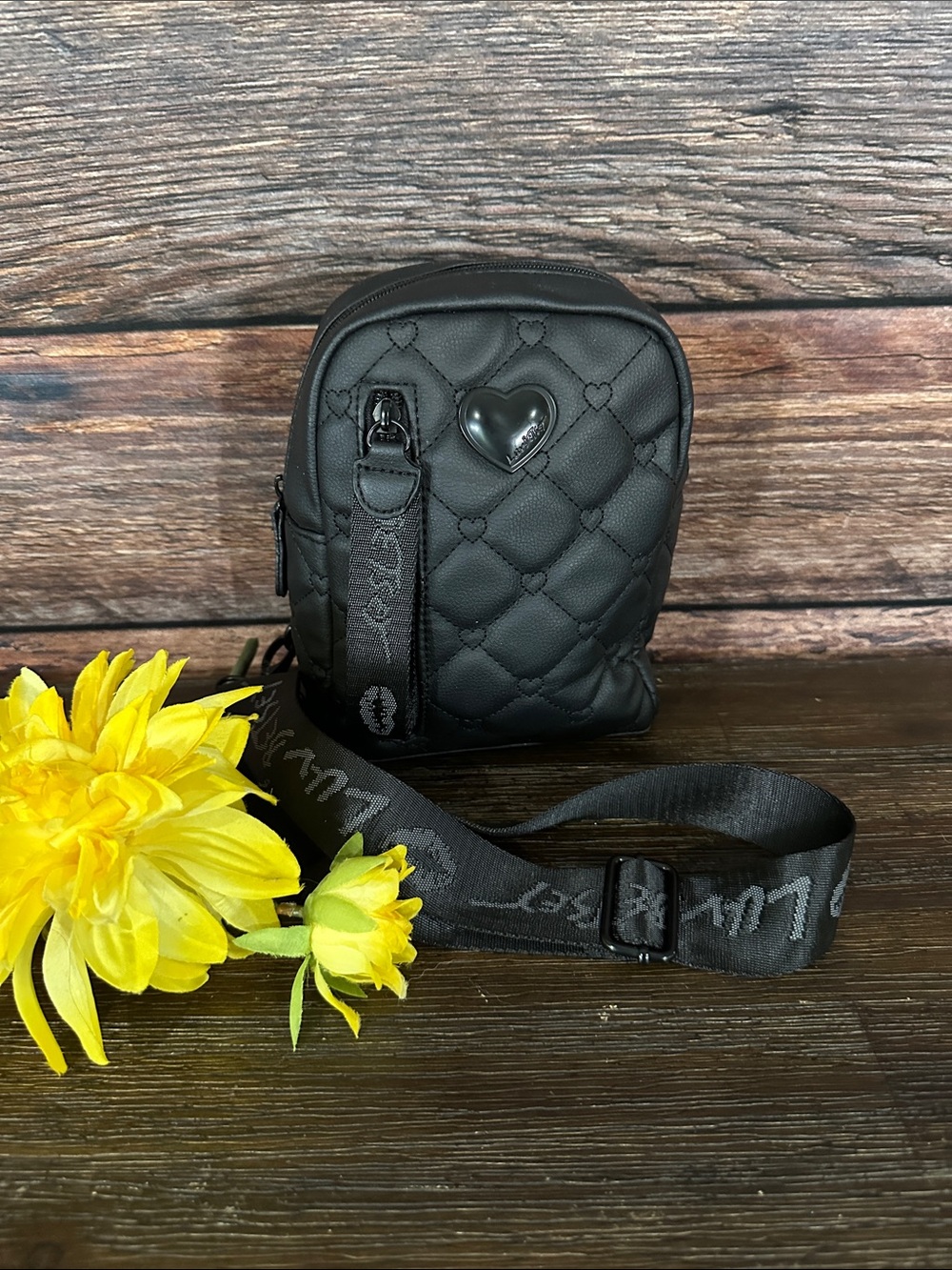 Luv Betsey by Betsey Johnson black quilted heart sling backpack.